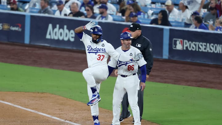 Oct 25, 2024; Los Angeles, California, USA; Los Angeles Dodgers outfielder Teoscar Hernandez (37) reacts on first after hitting a single in the seventh inning against the New York Yankees during game one of the 2024 MLB World Series at Dodger Stadium. Mandatory Credit: Kiyoshi Mio-Imagn Images