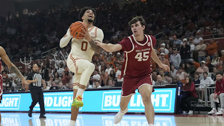 Mar 8, 2025; Austin, Texas, USA; Texas Longhorns guard Jordan Pope (0) drives to the basket against Oklahoma Sooners forward Luke Northweather (45) during the first half at Moody Center. Mandatory Credit: Scott Wachter-Imagn Images