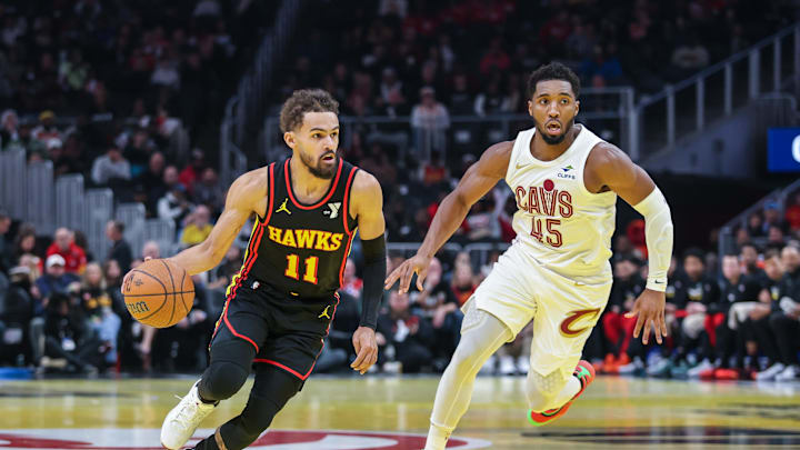 Nov 29, 2024; Atlanta, Georgia, USA; Atlanta Hawks guard Trae Young (11) dribbles the ball past Cleveland Cavaliers guard Donovan Mitchell (45) during the first quarter at State Farm Arena. Mandatory Credit: Jordan Godfree-Imagn Images