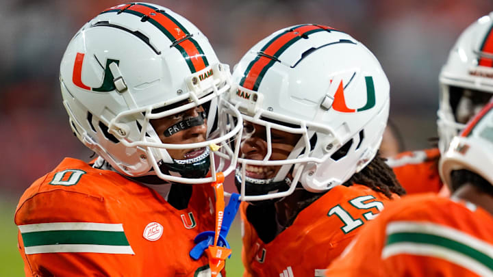Nov 8, 2025; Miami Gardens, Florida, USA; Miami Hurricanes wide receiver Keelan Marion (0) celebrates with wide receiver Daylyn Upshaw (15) after a touchdown pass against the Syracuse Orange during the third quarter at Hard Rock Stadium. Mandatory Credit: Jeff Romance-Imagn Images