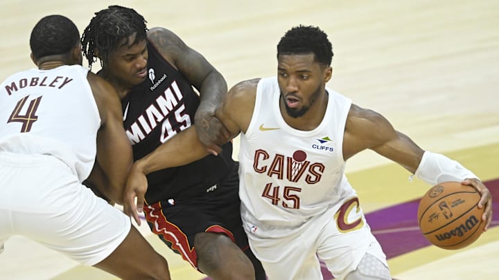 Apr 23, 2025; Cleveland, Ohio, USA; Cleveland Cavaliers forward Evan Mobley (4) sets a pick as guard Donovan Mitchell (45) dribbles around Miami Heat guard Davion Mitchell (45) in the fourth quarter of game two of the first round of the 2025 NBA Playoffs at Rocket Arena. Mandatory Credit: David Richard-Imagn Images