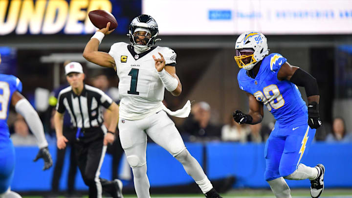 Dec 8, 2025; Inglewood, California, USA; Philadelphia Eagles quarterback Jalen Hurts (1) passes against Los Angeles Chargers linebacker Odafe Oweh (98) in the second half at SoFi Stadium. Dec 8, 2025; Inglewood, California, USA; Philadelphia Eagles quarterback Jalen Hurts (1) passes against Los Angeles Chargers linebacker Odafe Oweh (98) in the second half at SoFi Stadium.