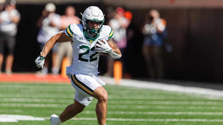 Sep 27, 2025; Stillwater, Oklahoma, USA; Baylor Bears running back Caden Knighten (22) runs the ball during the first half against the Oklahoma State Cowboys at Boone Pickens Stadium. Mandatory Credit: William Purnell-Imagn Images
