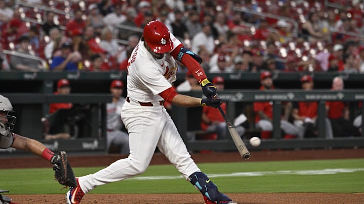 Sep 15, 2025; St. Louis, Missouri, USA; St. Louis Cardinals third baseman Nolan Arenado (28) hits a RBI single against the Cincinnati Reds in the second inning at Busch Stadium. Mandatory Credit: Joe Puetz-Imagn Images