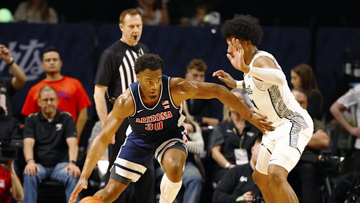 Jan 17, 2026; Orlando, Florida, USA;  Arizona Wildcats forward Tobe Awaka (30) tries to move towards the basket in the first half against the Central Florida Knights at Addition Financial Arena. Mandatory Credit: Russell Lansford-Imagn Images