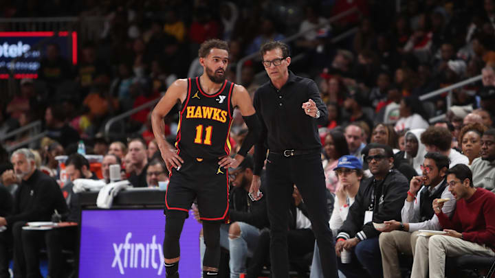 Mar 12, 2025; Atlanta, Georgia, USA; Atlanta Hawks guard Trae Young (11) and head coach Quin Snyder on the bench against the Charlotte Hornets during the second half at State Farm Arena. Mandatory Credit: Mady Mertens-Imagn Images