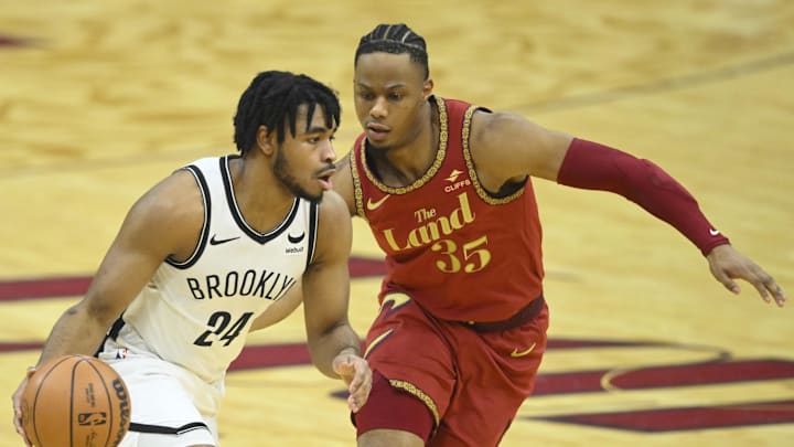 Mar 10, 2024; Cleveland, Ohio, USA; Brooklyn Nets guard Cam Thomas (24) dribbles beside Cleveland Cavaliers forward Isaac Okoro (35) in the first quarter at Rocket Mortgage FieldHouse. Mandatory Credit: David Richard-Imagn Images