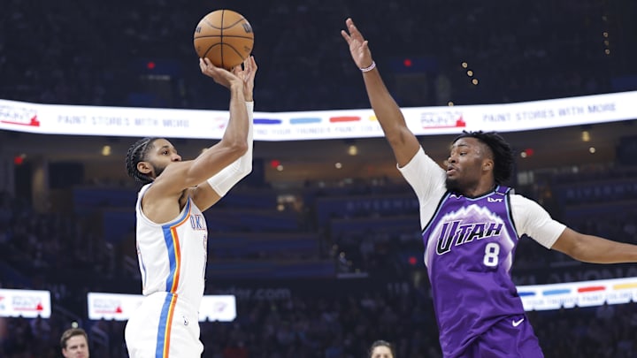Jan 7, 2026; Oklahoma City, Oklahoma, USA; Oklahoma City Thunder guard Isaiah Joe (11) shoots as Utah Jazz guard Isaiah Collier (8) defends during the second quarter at Paycom Center. Mandatory Credit: Alonzo Adams-Imagn Images