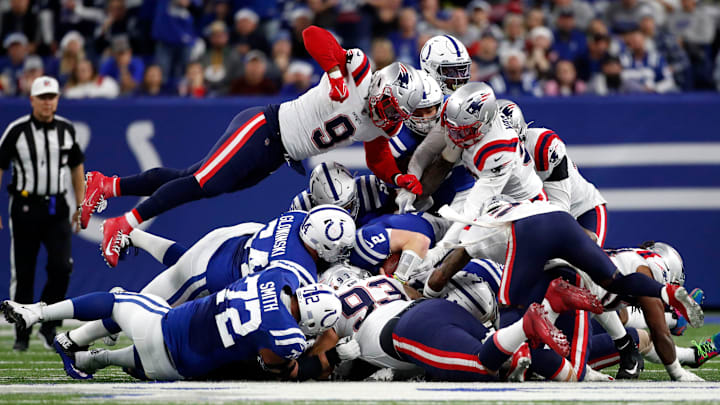 New England Patriots outside linebacker Matt Judon (9) dives on top of a pile of players Saturday, Dec. 18, 2021, during a game against the New England Patriots at Lucas Oil Stadium in Indianapolis.