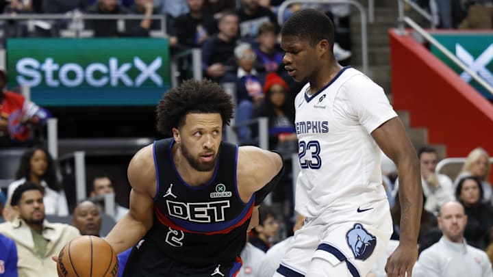 Mar 13, 2026; Detroit, Michigan, USA;  Detroit Pistons guard Cade Cunningham (2) dribbles defended by Memphis Grizzlies forward Cedric Coward (23) in the first half at Little Caesars Arena. Mandatory Credit: Rick Osentoski-Imagn Images