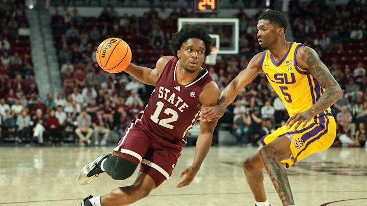 Mar 1, 2025; Starkville, Mississippi, USA; Mississippi State Bulldogs guard Josh Hubbard (12) drives to the basket against LSU Tigers guard Cam Carter (5) during the second half at Humphrey Coliseum. Mandatory Credit: Wesley Hale-Imagn Images