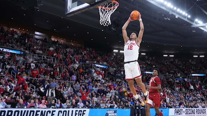 Mar 22, 2025; Providence, RI, USA; St. John's Red Storm guard RJ Luis Jr. (12) dunks against Arkansas Razorbacks forward Karter Knox (11) during the first half of a second round men’s NCAA Tournament game at Amica Mutual Pavilion. Mandatory Credit: Gregory Fisher-Imagn Images