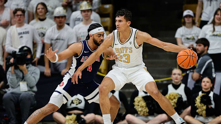 Colorado Buffaloes forward Tristan da Silva (23) controls the ball as Arizona Wildcats guard Kylan Boswell (4) guards him. Colorado Buffaloes forward Tristan da Silva (23) controls the ball as Arizona Wildcats guard Kylan Boswell (4) guards him.