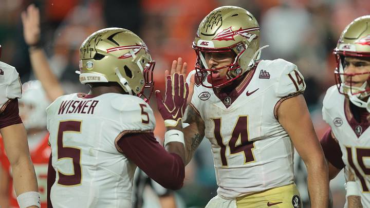 Oct 17, 2026; Miami Gardens, Florida, USA; Florida State Seminoles quarterback Ashton Daniels (14) celebrates with running back Quintrevion Wisner (5) after a touchdown during the second quarter against the Miami Hurricanes at Hard Rock Stadium. Mandatory Credit: Sam Navarro-Imagn Images Oct 17, 2026; Miami Gardens, Florida, USA; Florida State Seminoles quarterback Ashton Daniels (14) celebrates with running back Quintrevion Wisner (5) after a touchdown during the second quarter against the Miami Hurricanes at Hard Rock Stadium. Mandatory Credit: Sam Navarro-Imagn Images