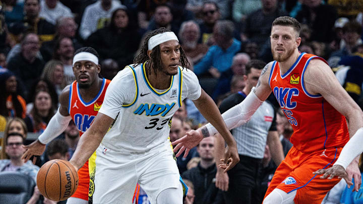 Dec 26, 2024; Indianapolis, Indiana, USA; Indiana Pacers center Myles Turner (33) passes the ball while Oklahoma City Thunder center Isaiah Hartenstein (55) defends in the second half at Gainbridge Fieldhouse. Mandatory Credit: Trevor Ruszkowski-Imagn Images