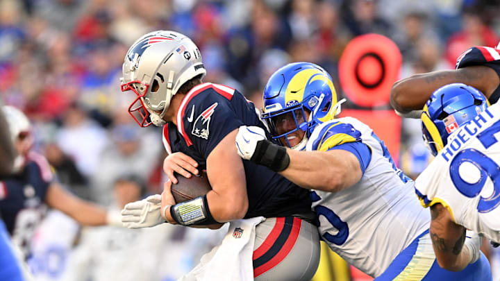 Nov 17, 2024; Foxborough, Massachusetts, USA; Los Angeles Rams defensive tackle Braden Fiske (55) tackles New England Patriots quarterback Drake Maye (10) during the second half at Gillette Stadium. Mandatory Credit: Brian Fluharty-Imagn Images