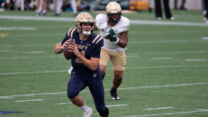USF defensive end Michael Williams (4) chases Navy quarterback Blake Horvath. USF defensive end Michael Williams (4) chases Navy quarterback Blake Horvath.