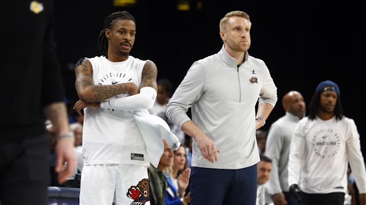 Mar 29, 2025; Memphis, Tennessee, USA; Memphis Grizzlies guard Ja Morant (left) and interim head coach Tuomas Iisalo (right) look on during the fourth quarter against the Los Angeles Lakers at FedExForum. Mandatory Credit: Petre Thomas-Imagn Images