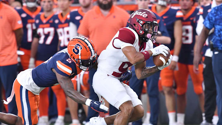 Sep 2, 2023; Syracuse, New York, USA; Colgate Raiders wide receiver Treyvhon Saunders (9) catches a pass as Syracuse Orange defensive back Alijah Clark (5) makes a tackle in the first quarter at the JMA Wireless Dome. Mandatory Credit: Mark Konezny-Imagn Images