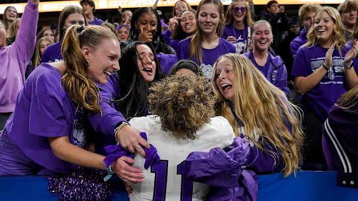 Brownsburg Bulldogs Drew Bostic (11) hugs fans Friday, Nov. 29, 2024, during the IHSAA Class 6A State Finals game at Lucas Oil Stadium in Indianapolis. The Brownsburg Bulldogs defeated the Westfield Shamrocks, 22-17.