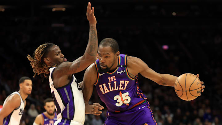 Mar 14, 2025; Phoenix, Arizona, USA; Phoenix Suns forward Kevin Durant (35) against Sacramento Kings guard Keon Ellis (23) at Footprint Center. Mandatory Credit: Mark J. Rebilas-Imagn Images
