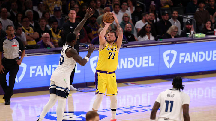 Apr 22, 2025; Los Angeles, California, USA; Los Angeles Lakers guard Luka Doncic (77) shoots the ball over Minnesota Timberwolves forward Julius Randle (30) during the third quarter of game two of first round for the 2024 NBA Playoffs at Crypto.com Arena. Mandatory Credit: Kiyoshi Mio-Imagn Images