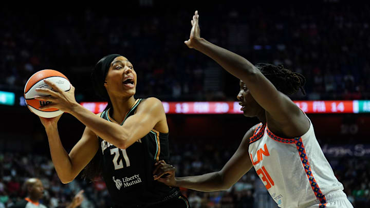Aug 3, 2025; Uncasville, Connecticut, USA; New York Liberty forward Isabelle Harrison (21) looks to pass the ball against Connecticut Sun center Tina Charles (31) in the second half at Mohegan Sun Arena. Mandatory Credit: David Butler II-Imagn Images