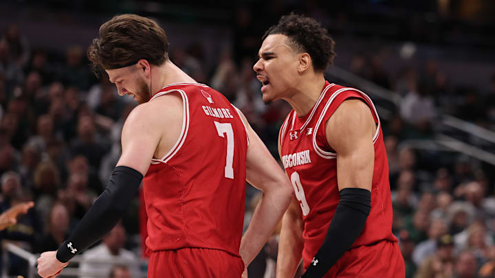  Carter Gilmore #7 and John Tonje #9 of the Wisconsin Badgers celebrate against the Michigan State Spartans during the second half in the Big Ten men's basketball tournament semifinals at Gainbridge Fieldhouse on March 15, 2025 in Indianapolis, Indiana.