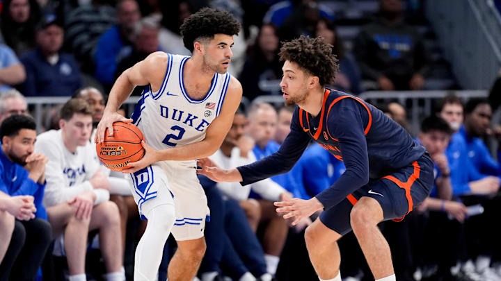 Mar 14, 2026; Charlotte, NC, USA; Virginia Cavaliers guard Sam Lewis (5) defends Duke Blue Devils guard Cayden Boozer (2) during the men's ACC Conference Tournament Championship at Spectrum Center. Mandatory Credit: Jim Dedmon-Imagn Images