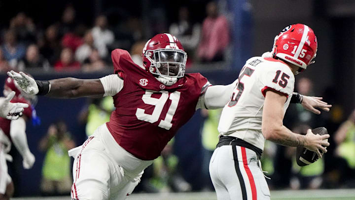 Dec 2, 2023; Atlanta, GA, USA;  Alabama Crimson Tide defensive lineman Jaheim Oatis (91) sacks Georgia Bulldogs quarterback Carson Beck (15) for a loss but was called for a face mask penalty at Mercedes-Benz Stadium. Alabama defeated Georgia 27-24 to claim the SEC Championship. Mandatory Credit: Gary Cosby Jr.-Imagn Images