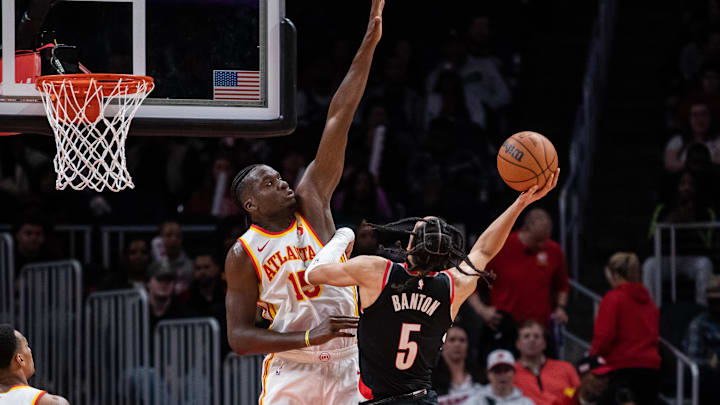 Mar 27, 2024; Atlanta, Georgia, USA; Portland Trail Blazers guard Dalano Banton (5) attempts to take shot against Atlanta Hawks center Clint Capela (15) during the fourth quarter at State Farm Arena. Mandatory Credit: Jordan Godfree-Imagn Images