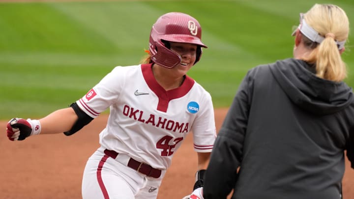 Oklahoma shortstop Gabbie Garcia high-fives Patty Gasso after hitting a home run at Love's Field. Oklahoma shortstop Gabbie Garcia high-fives Patty Gasso after hitting a home run at Love's Field.