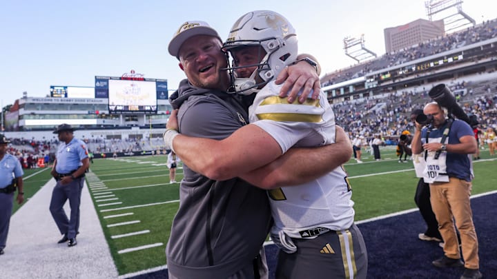 Oct 11, 2025; Atlanta, Georgia, USA; Georgia Tech Yellow Jackets head coach Brent Key and quarterback Haynes King (10) celebrate after a victory over the Virginia Tech Hokies at Bobby Dodd Stadium at Hyundai Field. Mandatory Credit: Brett Davis-Imagn Images
