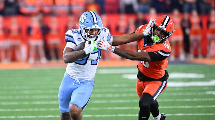 Oct 31, 2025; Syracuse, New York, USA; North Carolina Tar Heels running back Davion Gause (37) gives a stiff arm to Syracuse Orange defensive back Chris Peal (16) in the third quarter at the JMA Wireless Dome. 