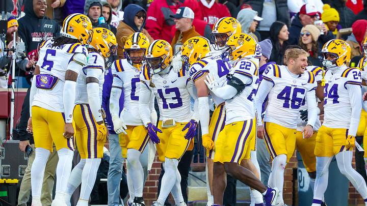 Nov 29, 2025; Norman, Oklahoma, USA; Louisiana State Tigers defensive back A.J. Haulcy (13) celebrates with teammates after intercepting a pass during the third quarter against the Oklahoma Sooners at Gaylord Family-Oklahoma Memorial Stadium. Mandatory Credit: Kevin Jairaj-Imagn Images Nov 29, 2025; Norman, Oklahoma, USA; Louisiana State Tigers defensive back A.J. Haulcy (13) celebrates with teammates after intercepting a pass during the third quarter against the Oklahoma Sooners at Gaylord Family-Oklahoma Memorial Stadium. Mandatory Credit: Kevin Jairaj-Imagn Images