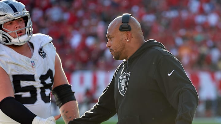 Dec 8, 2024; Tampa, Florida, USA; Las Vegas Raiders head coach Antonio Pierce and guard Jackson Powers-Johnson (58) high five against the Tampa Bay Buccaneers during the second half at Raymond James Stadium. Mandatory Credit: Kim Klement Neitzel-Imagn Images
