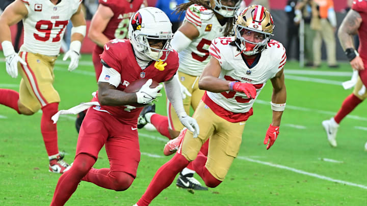 Jan 5, 2025; Glendale, Arizona, USA;  Arizona Cardinals wide receiver Greg Dortch (4) runs the ball as San Francisco 49ers cornerback Nick McCloud (35) defends in the second half at State Farm Stadium. Mandatory Credit: Matt Kartozian-Imagn Images