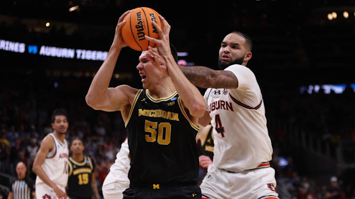 Mar 28, 2025; Atlanta, GA, USA; Michigan Wolverines center Vladislav Goldin (50) drives against Auburn Tigers forward Johni Broome (4) in the second half of a South Regional semifinal of the 2025 NCAA tournament at State Farm Arena. Mandatory Credit: Brett Davis-Imagn Images