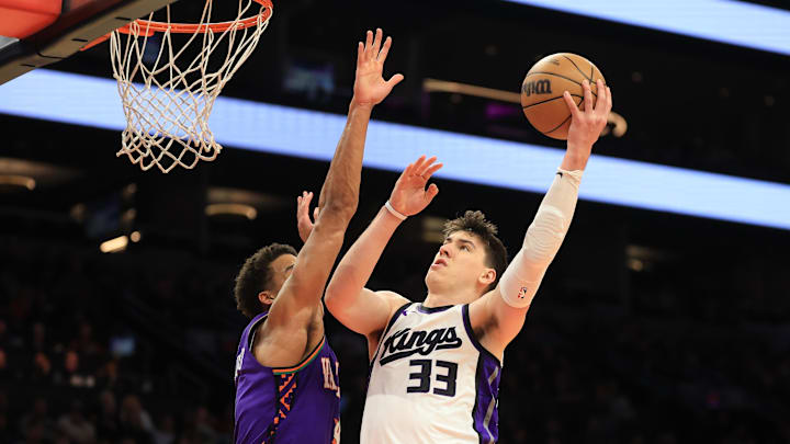 Mar 14, 2025; Phoenix, Arizona, USA; Sacramento Kings forward Jake LaRavia (33) shoots the ball against the Phoenix Suns during the second half at Footprint Center. Mandatory Credit: Mark J. Rebilas-Imagn Images