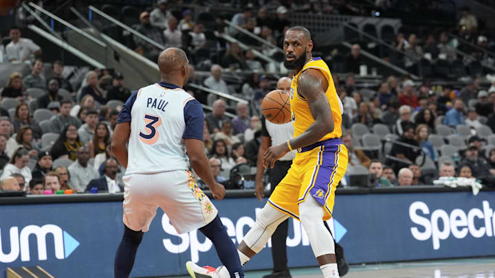 Nov 27, 2024; San Antonio, Texas, USA; Los Angeles Lakers forward LeBron James (23) controls the ball in front of San Antonio Spurs guard Chris Paul (3) in the second half at Frost Bank Center. Mandatory Credit: Daniel Dunn-Imagn Images Nov 27, 2024; San Antonio, Texas, USA; Los Angeles Lakers forward LeBron James (23) controls the ball in front of San Antonio Spurs guard Chris Paul (3) in the second half at Frost Bank Center. Mandatory Credit: Daniel Dunn-Imagn Images