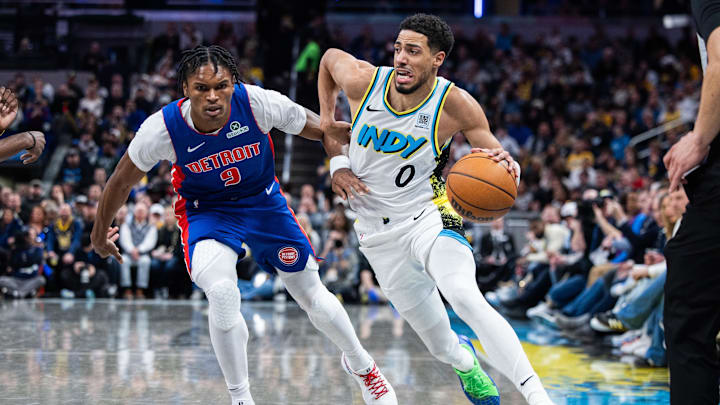 Jan 29, 2025; Indianapolis, Indiana, USA; Indiana Pacers guard Tyrese Haliburton (0) dribbles the ball while Detroit Pistons forward Ausar Thompson (9) defends in the first half at Gainbridge Fieldhouse. Mandatory Credit: Trevor Ruszkowski-Imagn Images
