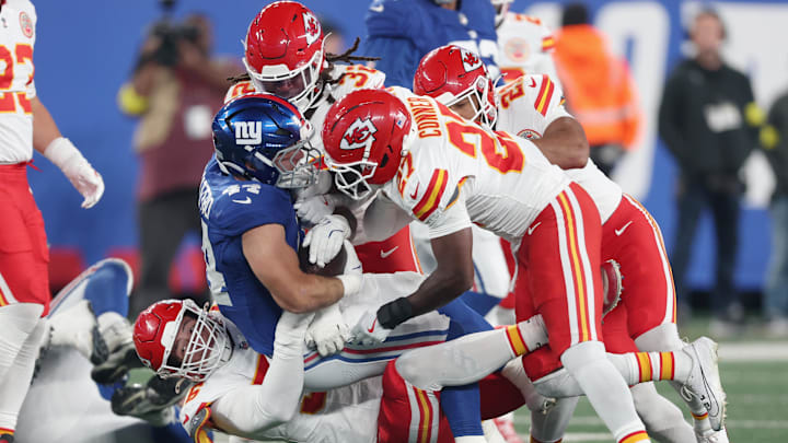 Sep 21, 2025; East Rutherford, New Jersey, USA; Kansas City Chiefs defensive end George Karlaftis (56) and defensive back Chamarri Conner (27) and linebacker Nick Bolton (32) tackle New York Giants running back Cam Skattebo (44) in the first quarter at MetLife Stadium. Mandatory Credit: Vincent Carchietta-Imagn Images