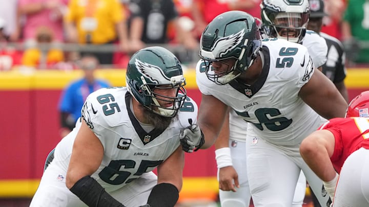 Sep 14, 2025; Kansas City, Missouri, USA; Philadelphia Eagles offensive tackle Lane Johnson (65) talks with guard Tyler Steen (56) on the line of scrimmage against the Kansas City Chiefs during the game at GEHA Field at Arrowhead Stadium. Mandatory Credit: Denny Medley-Imagn Images