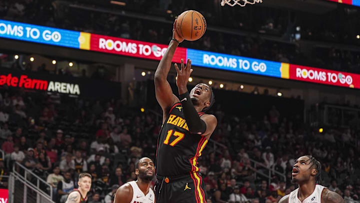 Apr 18, 2025; Atlanta, Georgia, USA; Atlanta Hawks forward Onyeka Okongwu (17) shoots at the basket behind Miami Heat guard Davion Mitchell (45) during the first half at State Farm Arena. Mandatory Credit: Dale Zanine-Imagn Images