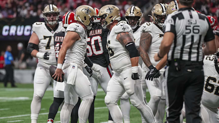 Sep 29, 2024; Atlanta, Georgia, USA; New Orleans Saints tight end Taysom Hill (7) reacts with center Shane Lemieux (66) after scoring a touchdown against the Atlanta Falcons during the first quarter at Mercedes-Benz Stadium. Mandatory Credit: Dale Zanine-Imagn Images Sep 29, 2024; Atlanta, Georgia, USA; New Orleans Saints tight end Taysom Hill (7) reacts with center Shane Lemieux (66) after scoring a touchdown against the Atlanta Falcons during the first quarter at Mercedes-Benz Stadium. Mandatory Credit: Dale Zanine-Imagn Images