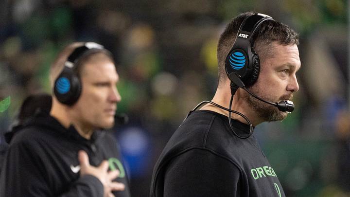 Oregon coach Dan Lanning and defensive coordinator Tosh Lupoi call the game against James Madison from the sidelines at Autzen Stadium in Eugene Dec. 20, 2025.