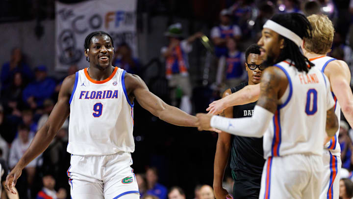 Florida Gators center Rueben Chinyelu (9) smiles with forward Thomas Haugh (10)
