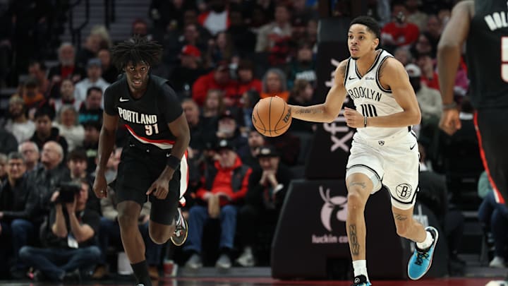 Mar 23, 2026; Portland, Oregon, USA; Brooklyn Nets forward Josh Minott (00) brings the ball up the court past Portland Trail Blazers guard Sidy Cissoko (91) during the second half at Moda Center. Mandatory Credit: Jaime Valdez-Imagn Images