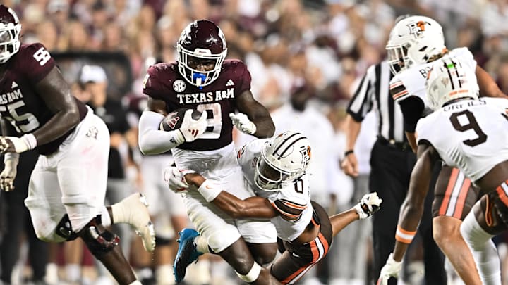 Sep 21, 2024; College Station, Texas, USA; Texas A&M Aggies running back Le'Veon Moss (8) runs the ball as Bowling Green Falcons cornerback Darius McClendon (0) attempts a tackle during the second quarter at Kyle Field. Mandatory Credit: Maria Lysaker-Imagn Images. 