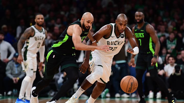 Dec 6, 2024; Boston, Massachusetts, USA;  Boston Celtics guard Derrick White (9) and Milwaukee Bucks forward Khris Middleton (22) battle for a loose ball during the second half at TD Garden. Mandatory Credit: Bob DeChiara-Imagn Images